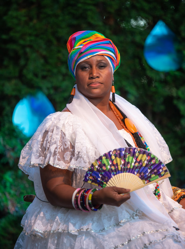 FIRE FLOWERS AND A​ ​TIME MACHINE // FLORES DE FUEGO Y UNA MÁQUINA DEL TIEMPO by Shey Rivera Ríos, presented by The Wilbury Theatre Group in collaboration with WaterFire Providence; photo by Erin X. Smithers. (Providence, RI)